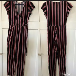 Black jumpsuit with white, pink, & burgundy stripes by Derek Heart. Size: Small